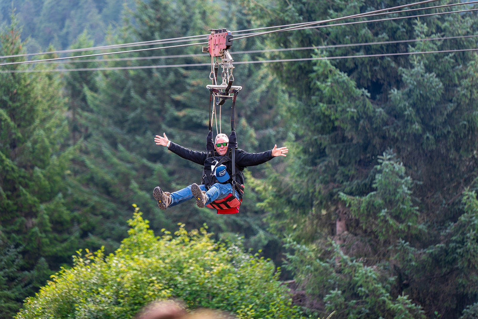 Man ziplining through forest