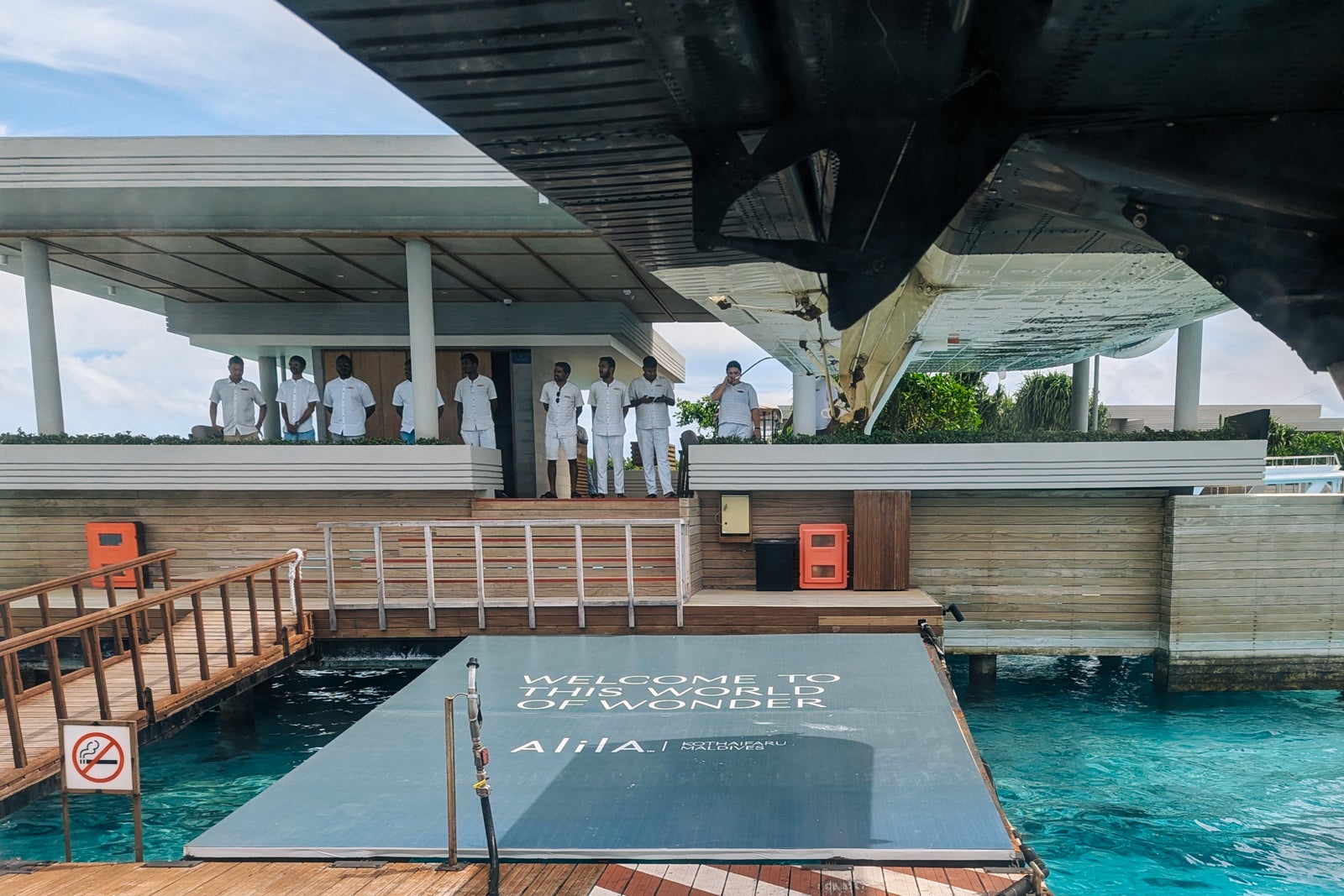 Staff greeting a seaplane at Alila Kothaifaru Maldives