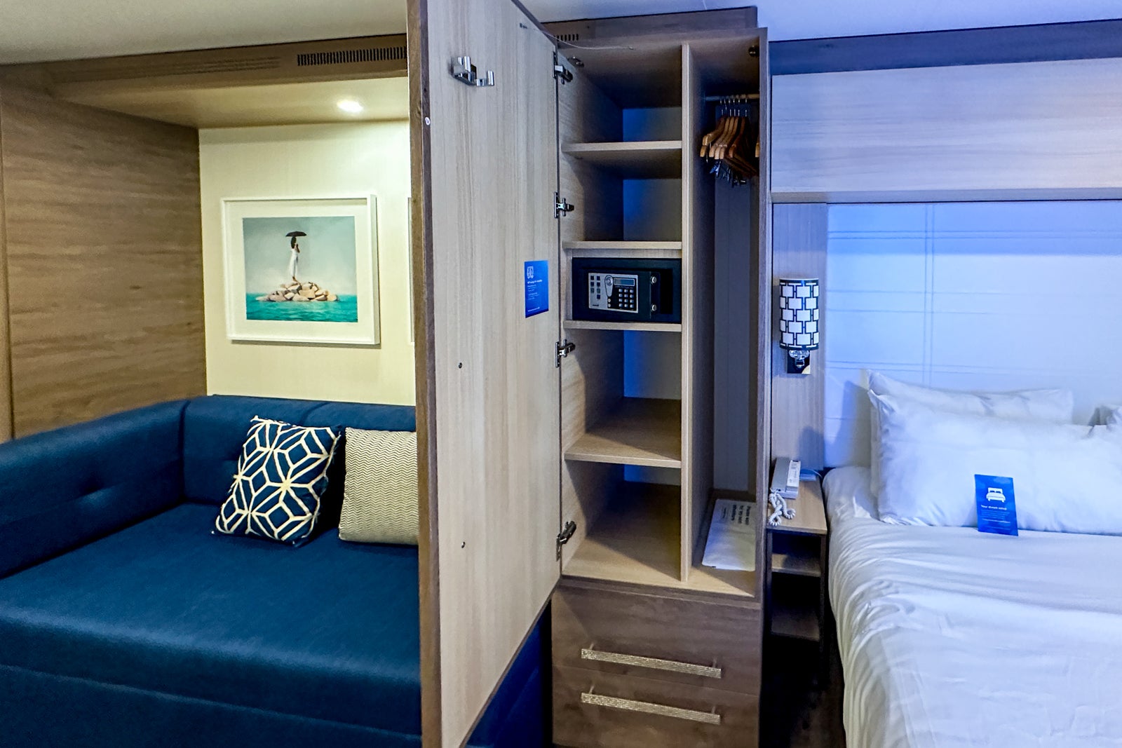 Storage space between a sofa and the bed in a cruise ship cabin