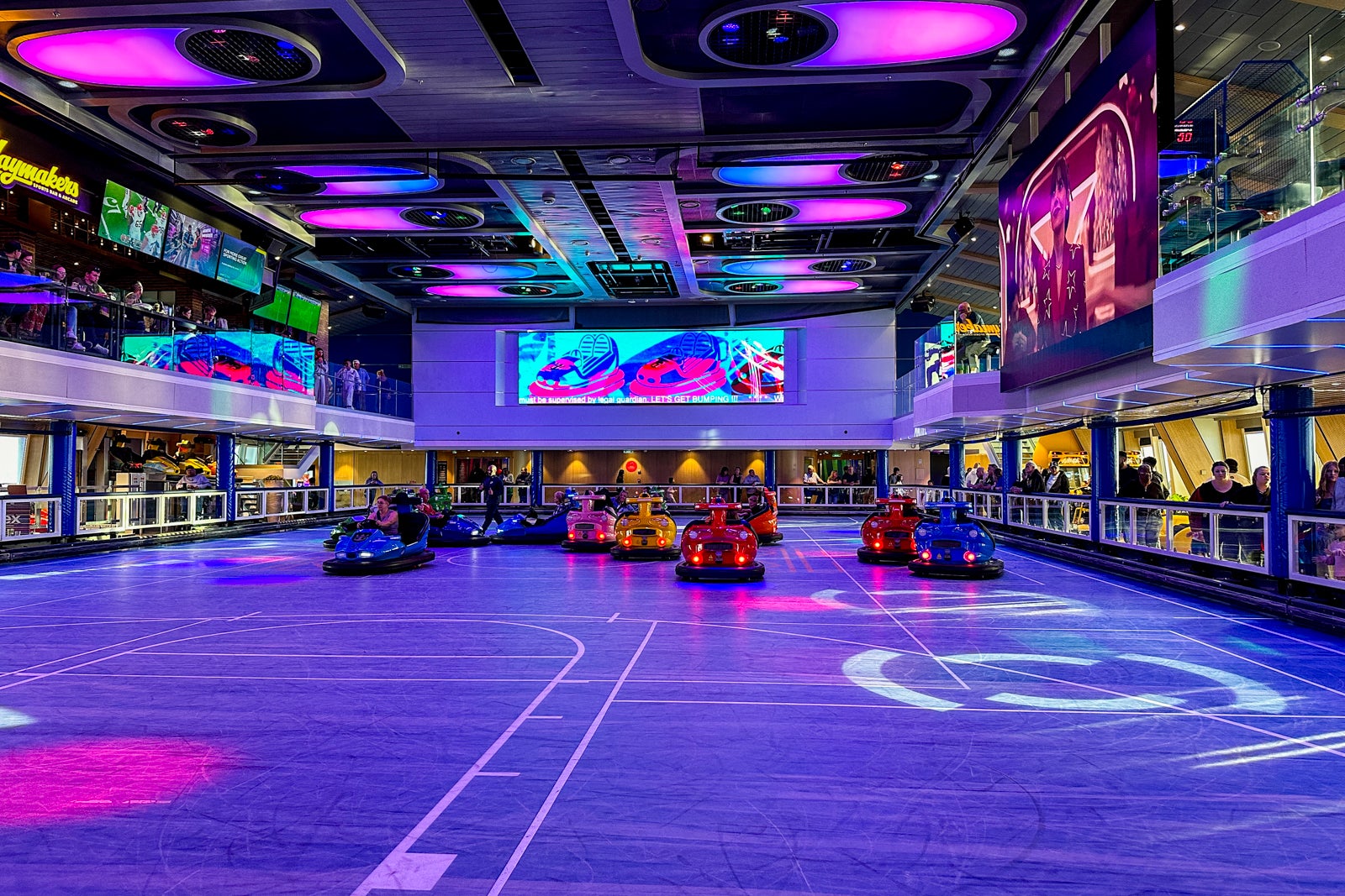 Passengers riding in bumper cars on a cruise ship sports court