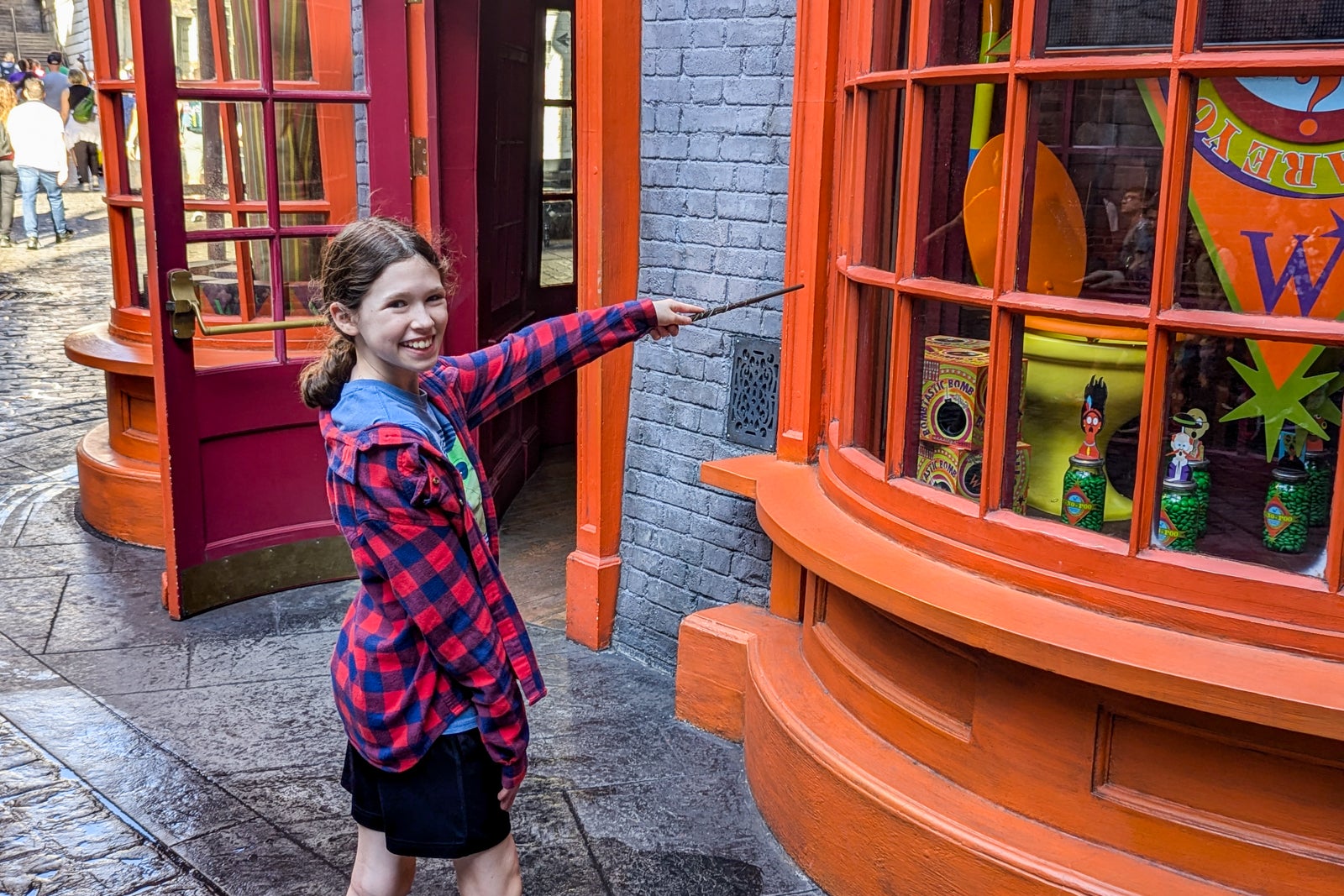 Girl using wand in Diagon Alley