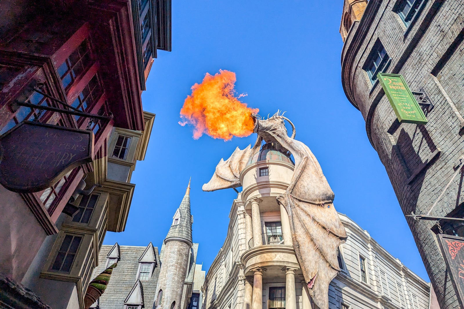 Dragon breathing fire on top of building