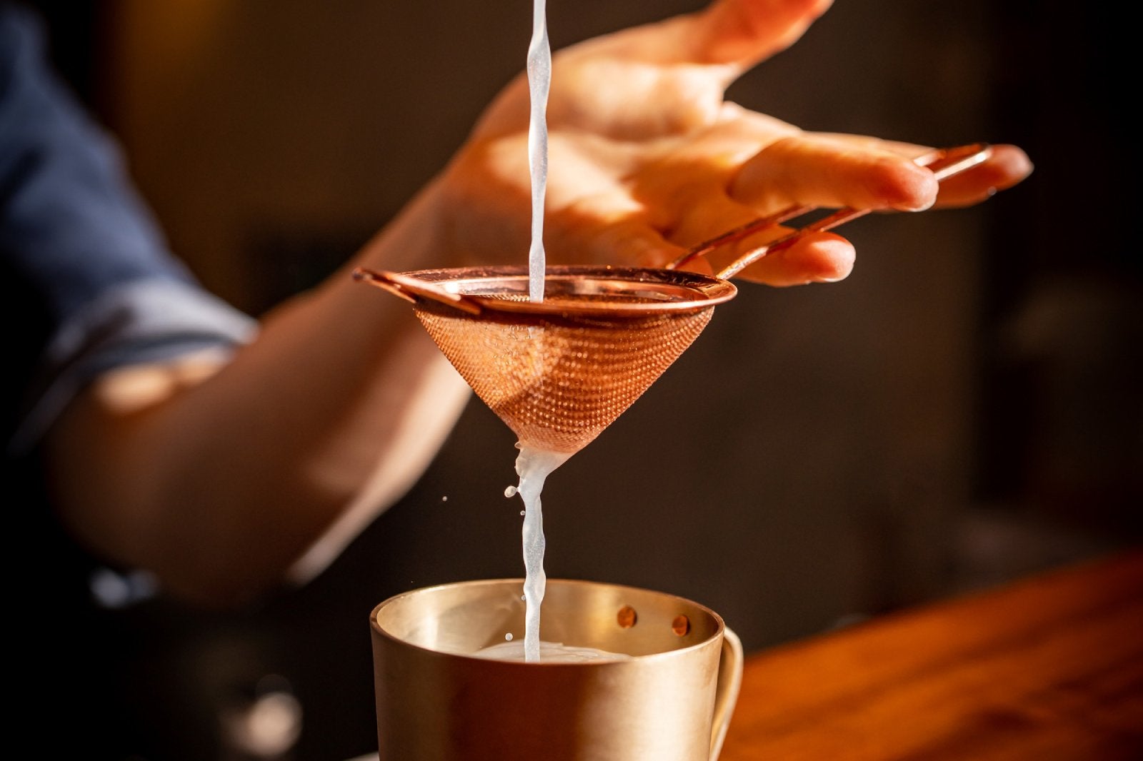 straining a drink into a teacup at Four Seasons Hotel Seoul