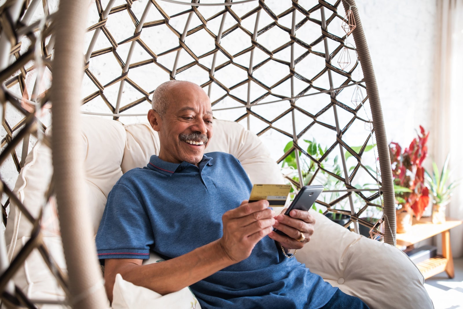 Man holding a credit card and cell phone