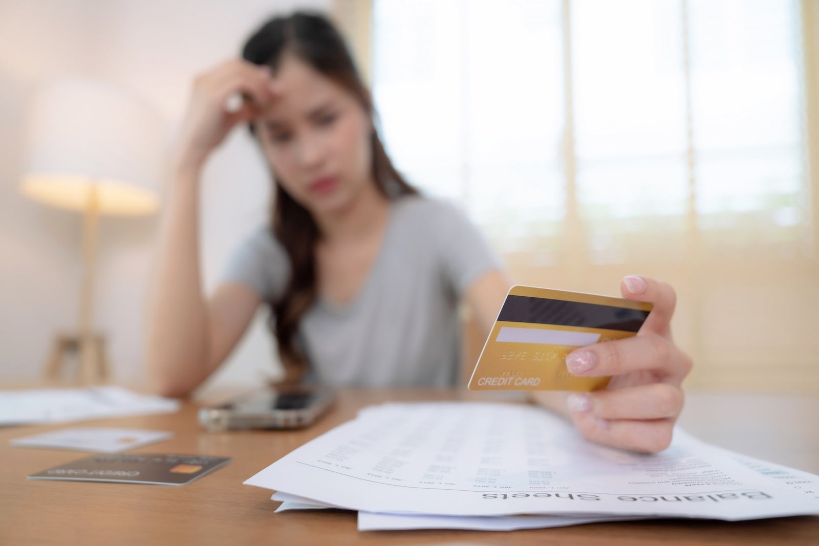 Stressed woman with credit card 