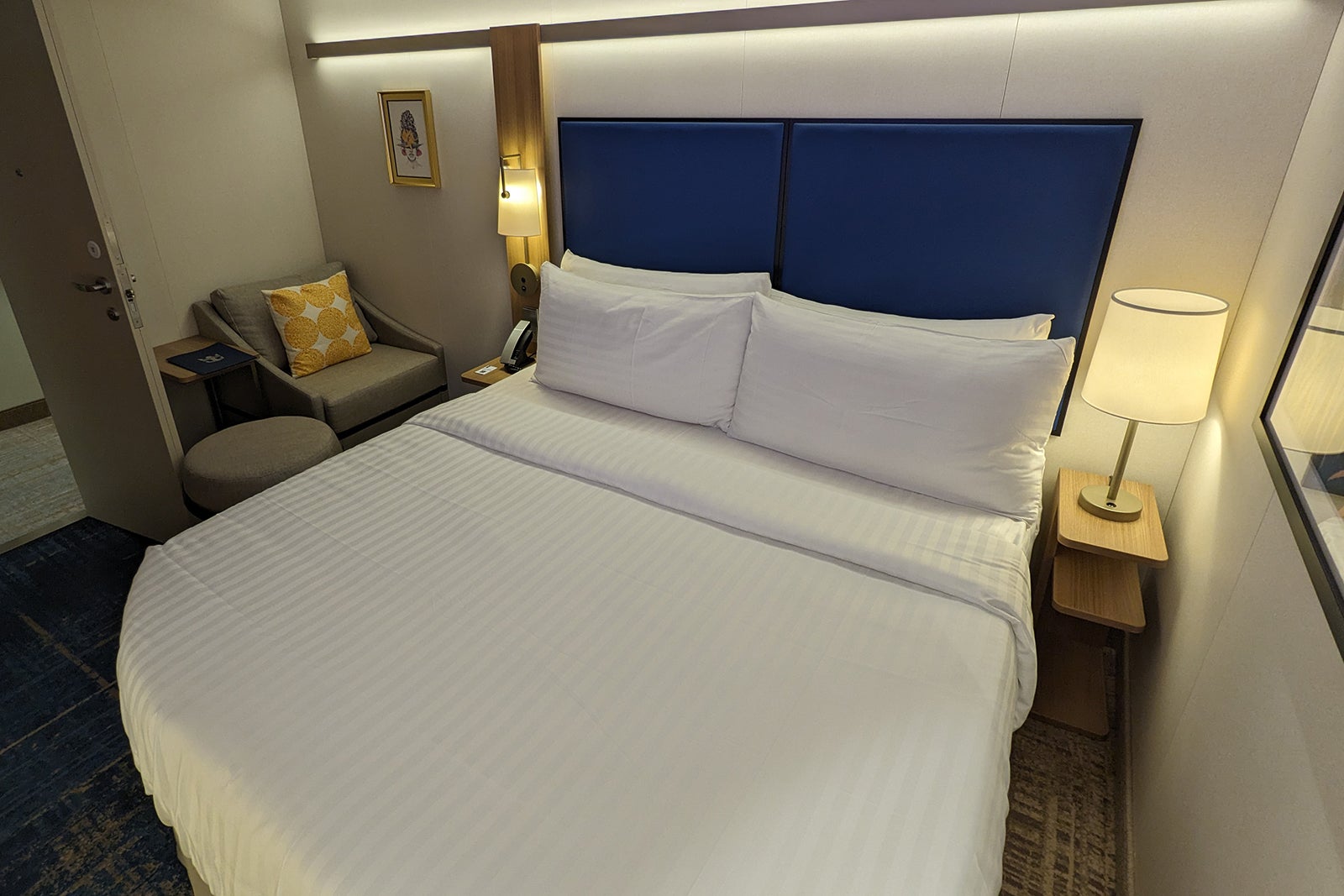 Bed and desk chair in inside cruise cabin