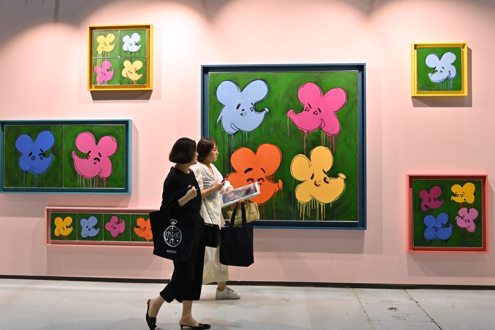 Visitors walk past an artwork named "Who are the Flowers?, 2023" by artist Simon Fujiwara during the Frieze Seoul 2023 art fair in Seoul on September 6, 2023.