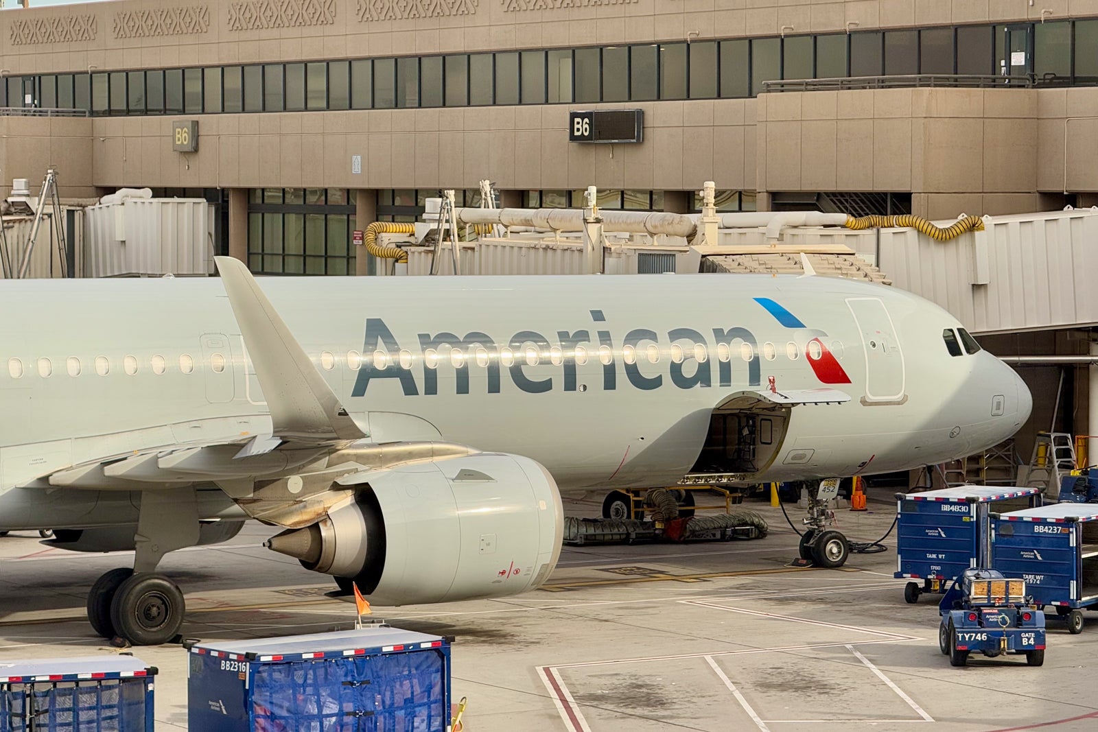 an American Airlines plane parked at an airport gate