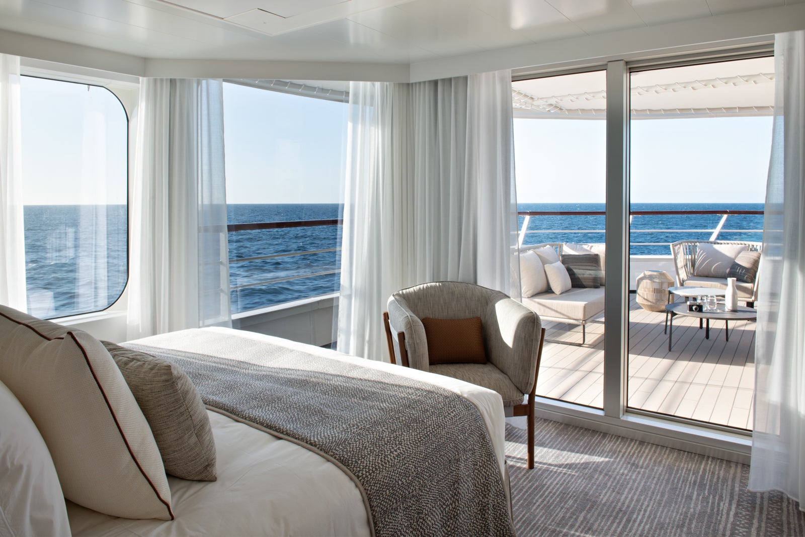 The view from a cruise bed with windows looking out to deck and ocean.