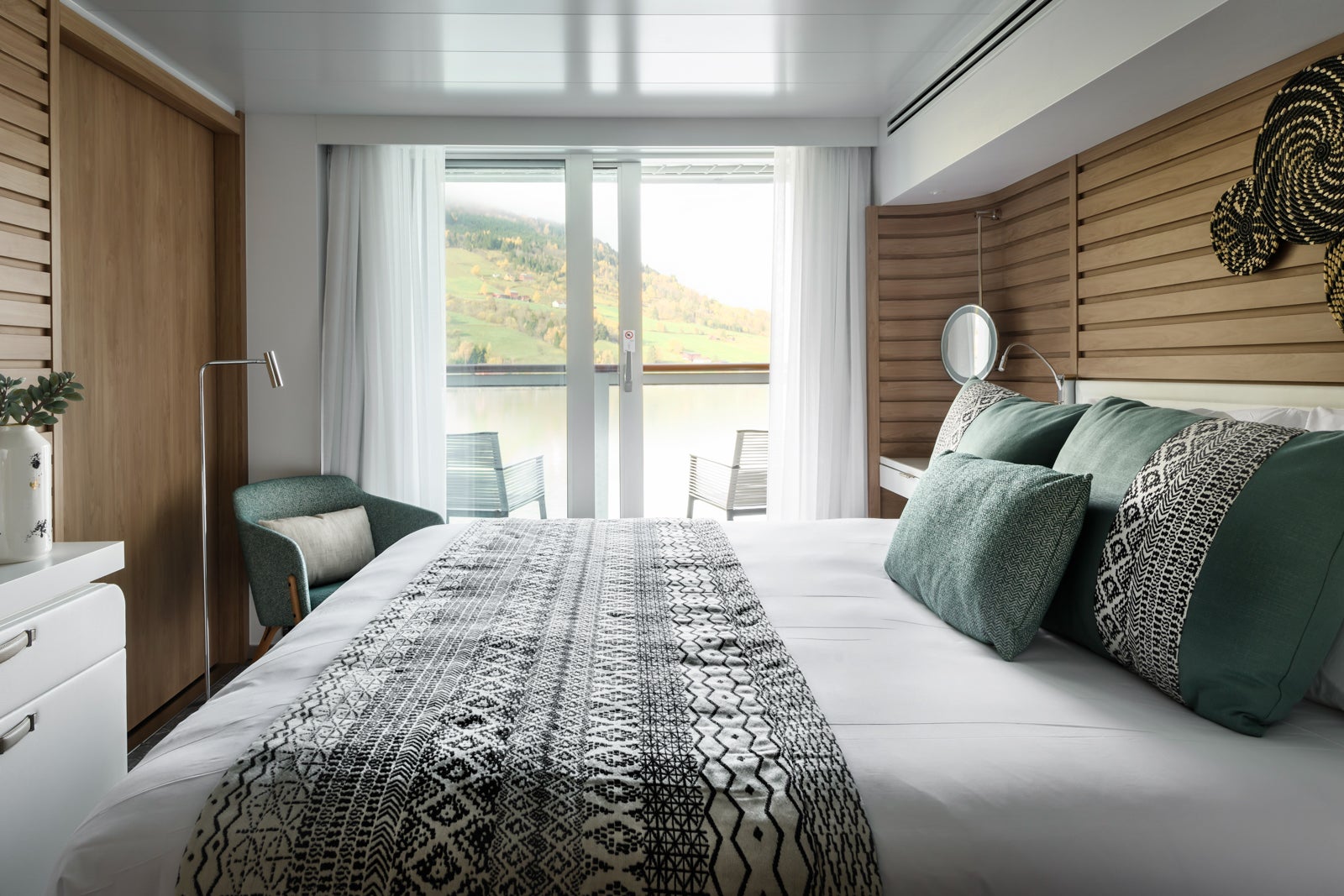 Inside a balcony cabin that looks out onto the water.