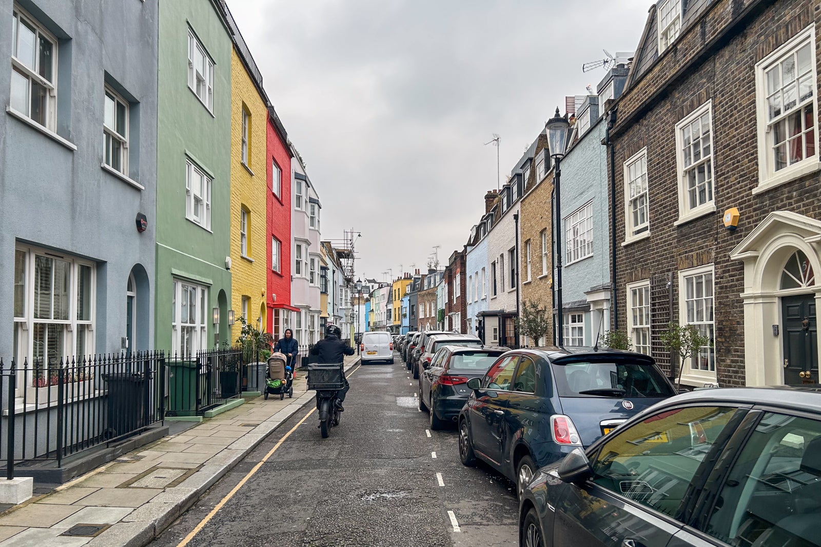 Street scene with colorful pastel apartment buildings in London's Chelsea neighborhood on a gray day in February.