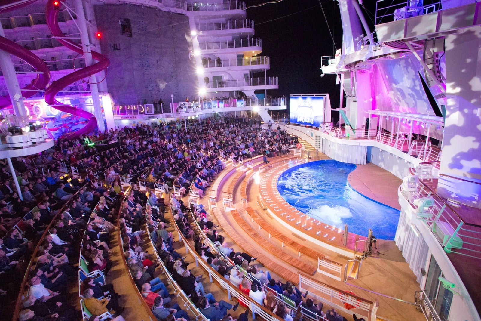 An aerial side view of a fully booked performance at the AquaTheater on one of Royal Caribbean's ships