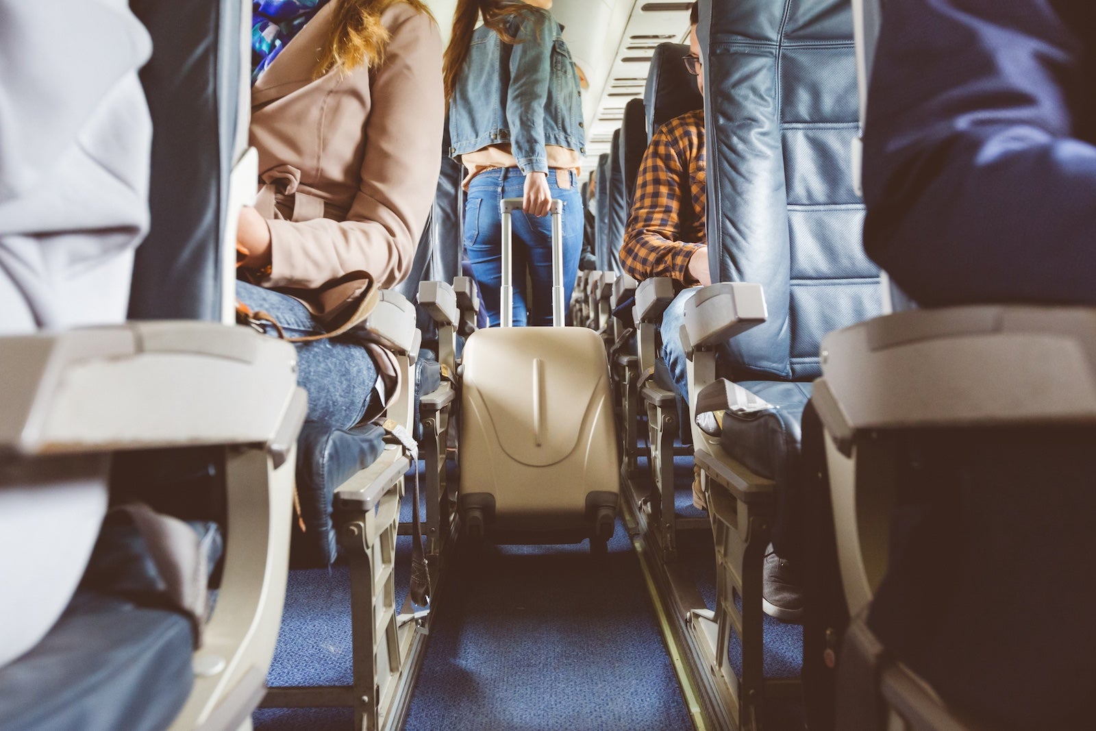 Interior of airplane with people sitting on seats