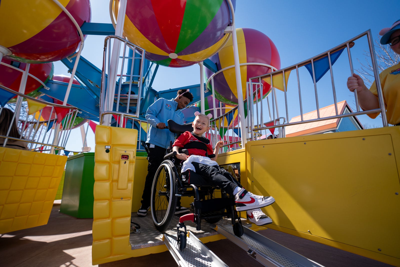 child in wheelchair on theme park ride