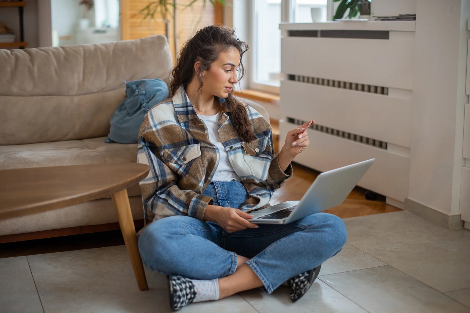 Woman sitting on the floor with a laptop