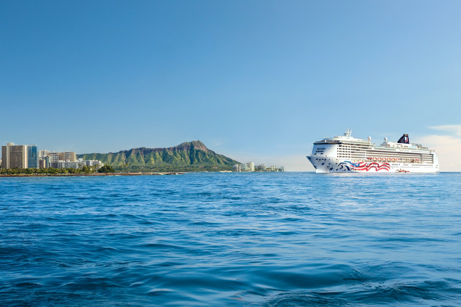 Cruise ship sailing into Honolulu, approaching Diamond Head and skyscrapers