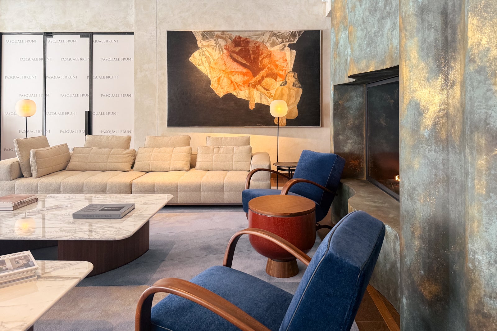 The lobby with couches and fireplace at Fairmont Golden Prague.
